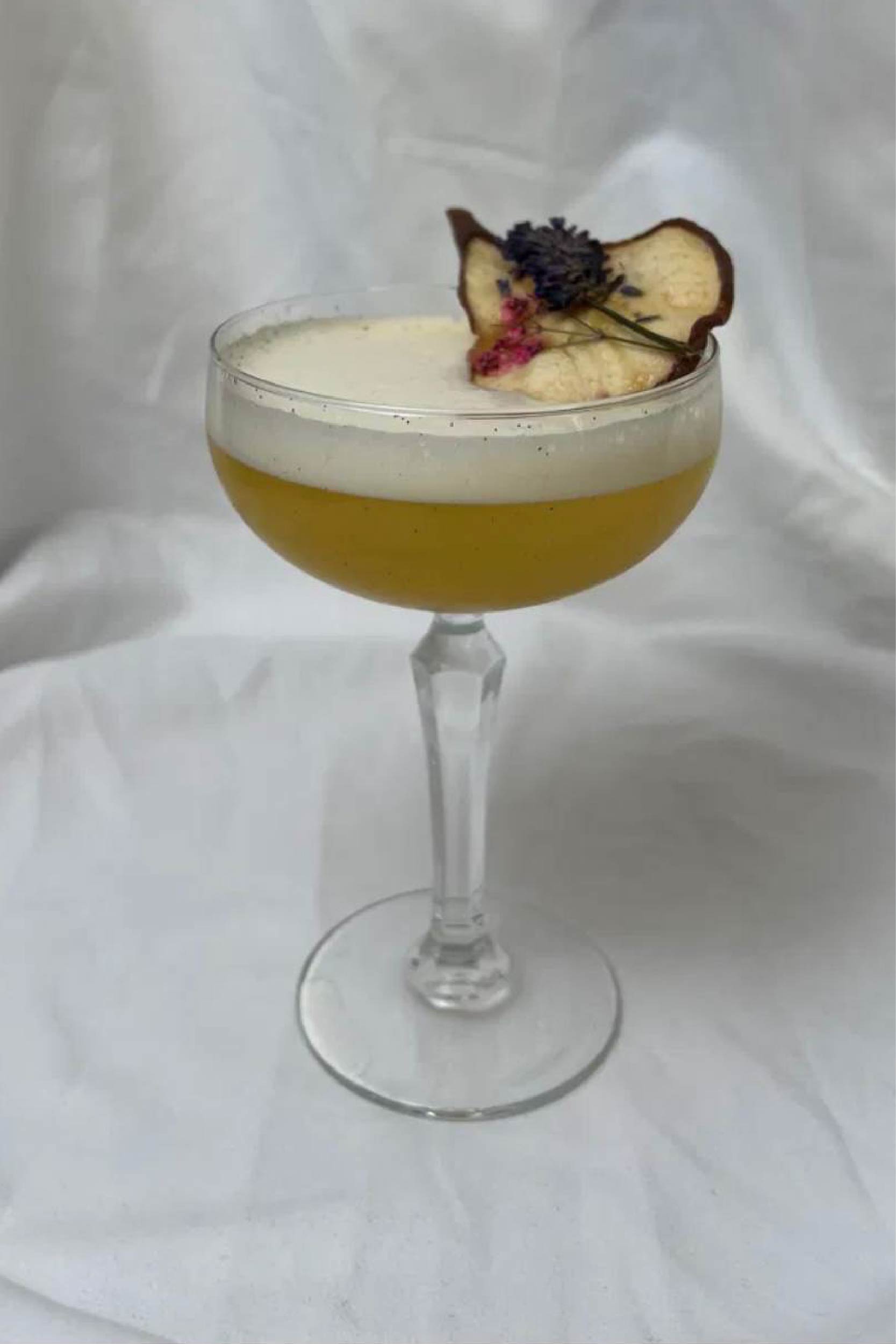 Nocturne — amber Manhattan with green apple garnish